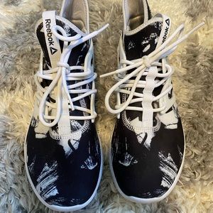 Black and white Reebok slip on shoes